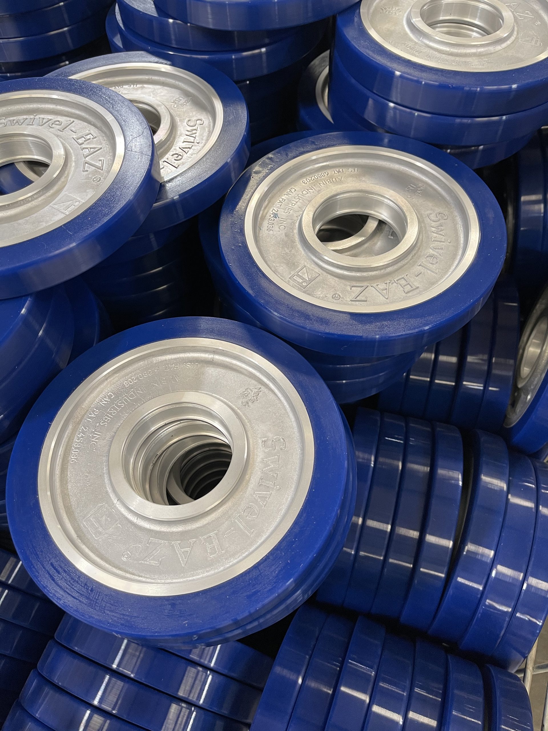 Blue Swivel-EAZ® wheels manufactured by Aubin Industries, Inc.